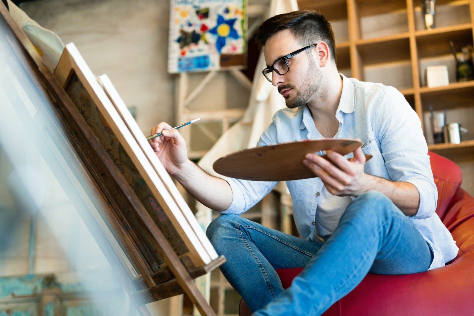 male art school artist painting with oil on canvas